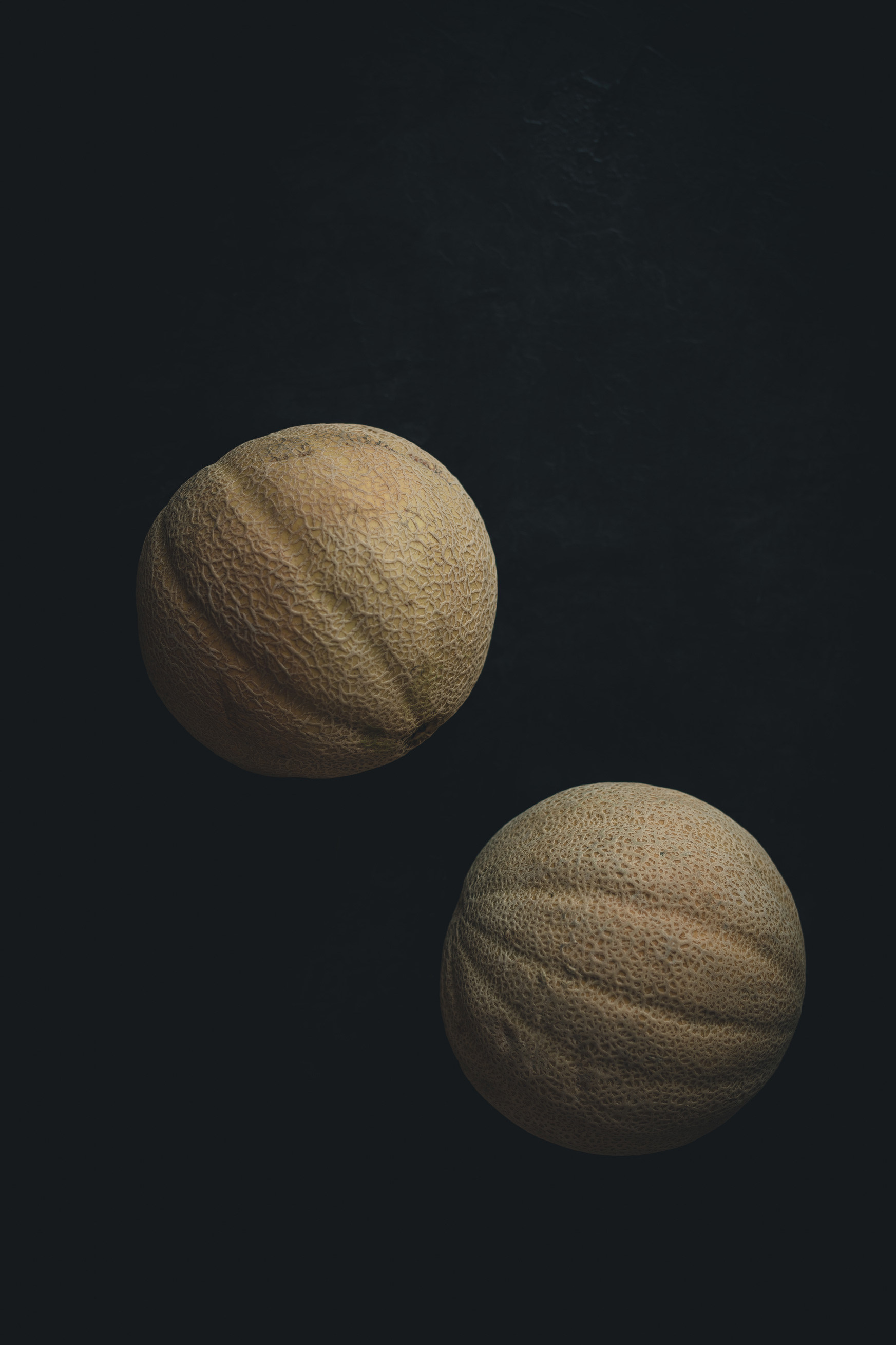 Cantaloupe on a black background from the Moody Food series by John Robson Photography