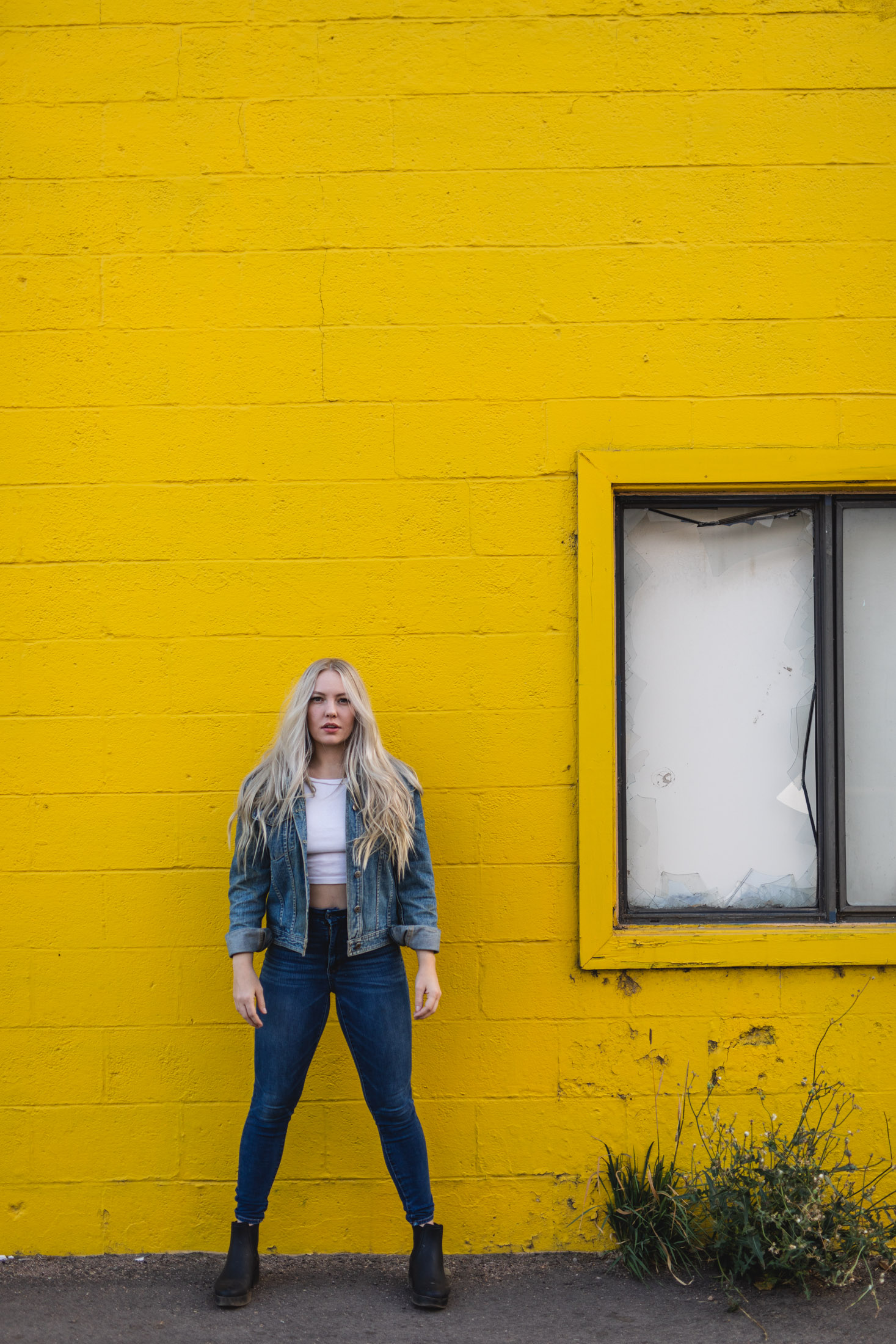 Lifestyle model posing in front of a yellow wall - John Robson Photography