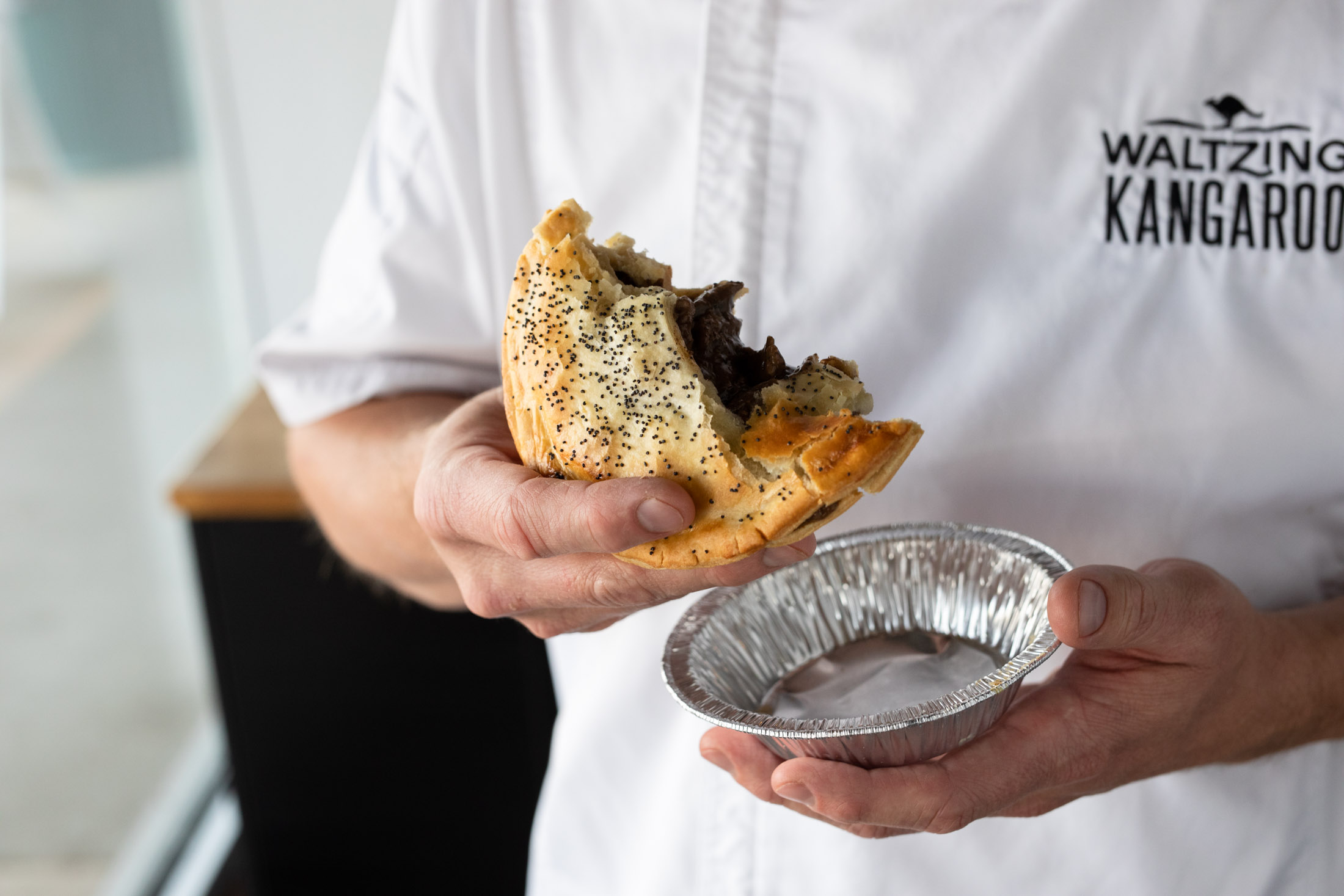 Meat pie being eaten by chef at Waltzing Kangaroo in Fort Collins, Colorado - John Robson Photography