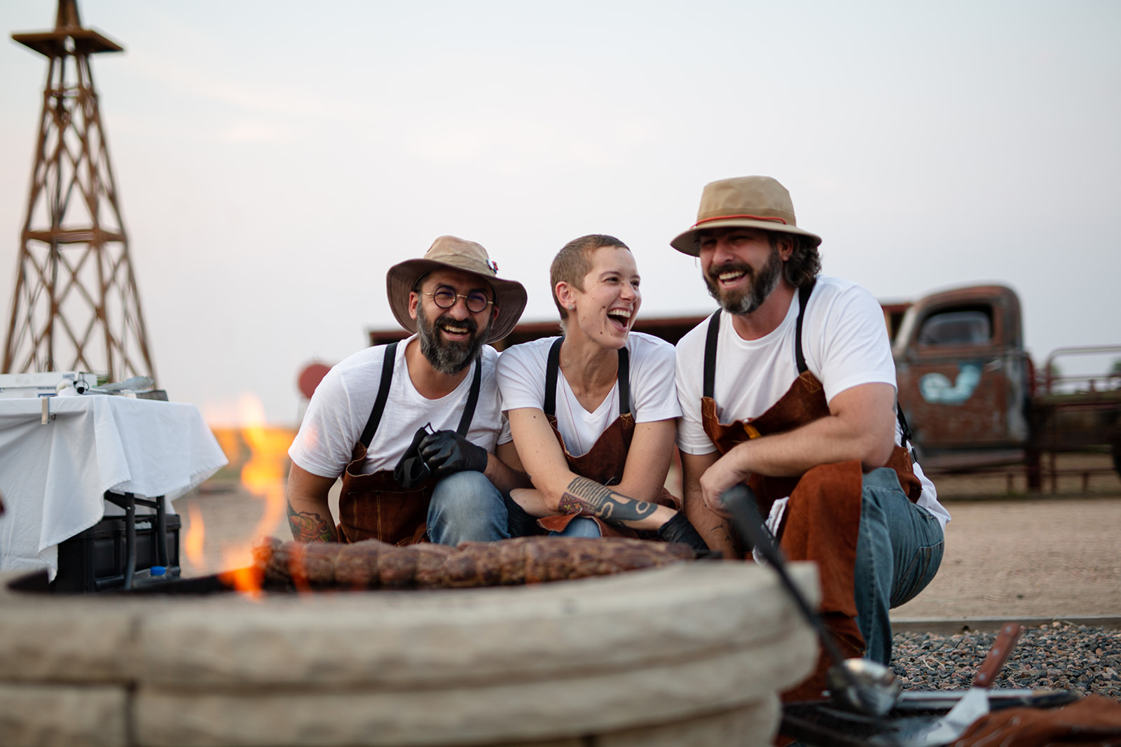 Chefs posing by a fire pit at an outdoor event in Greeley, Colorado