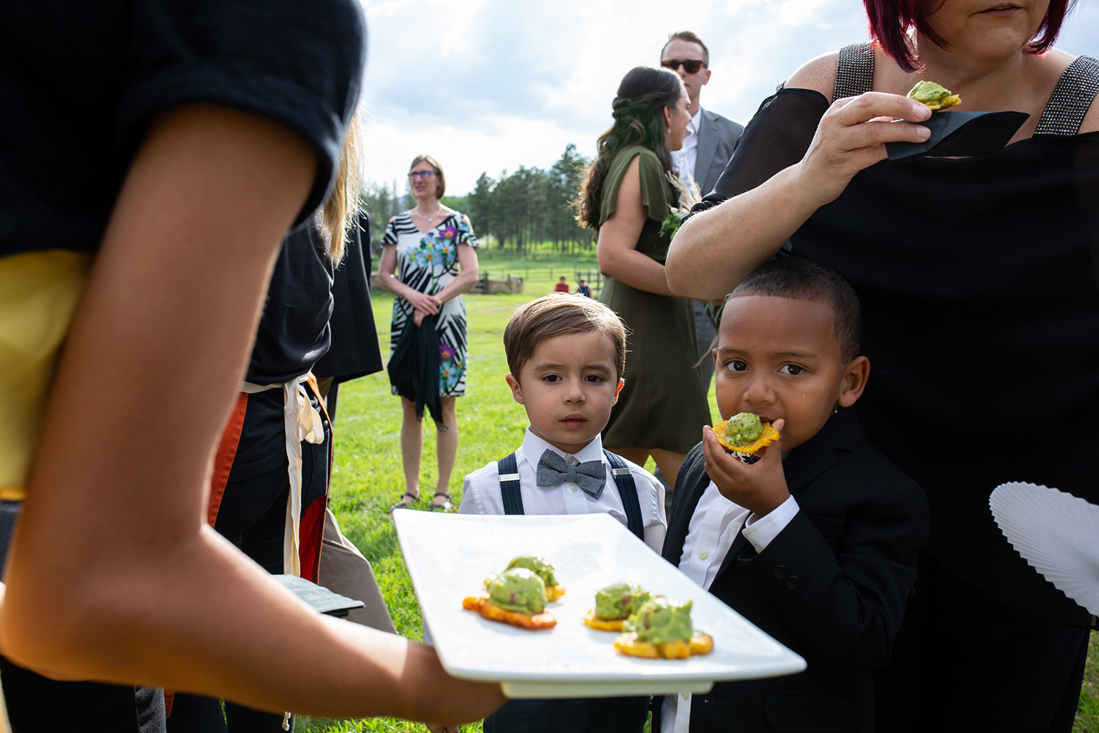 Boys being served and eating appetizers at a wedding in Colorado - John Robson Photography