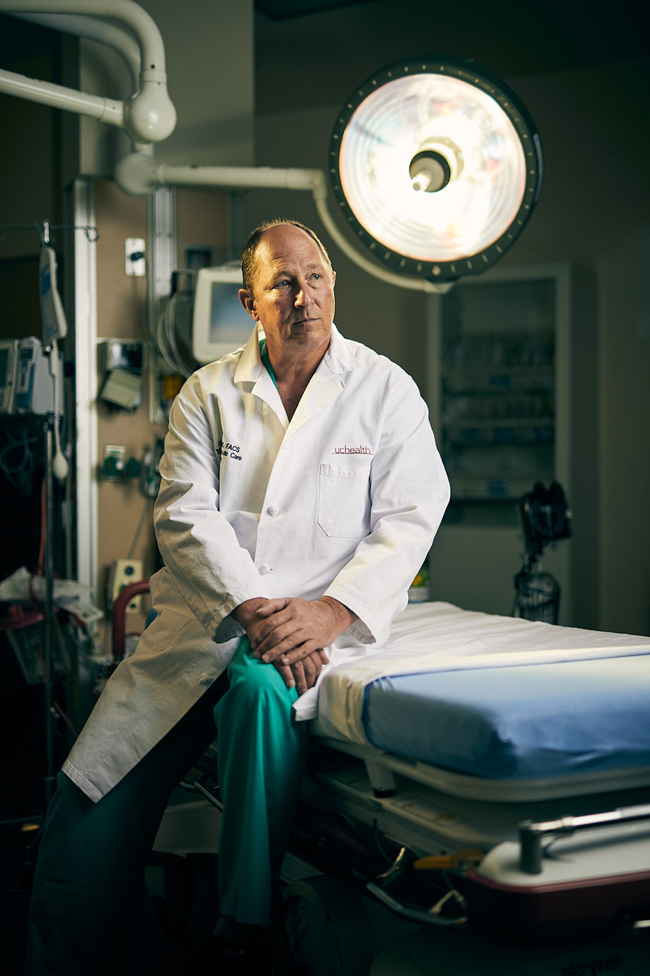 Editorial portrait of MCR- Trauma Center doctor sitting on gurney - John Robson Photography