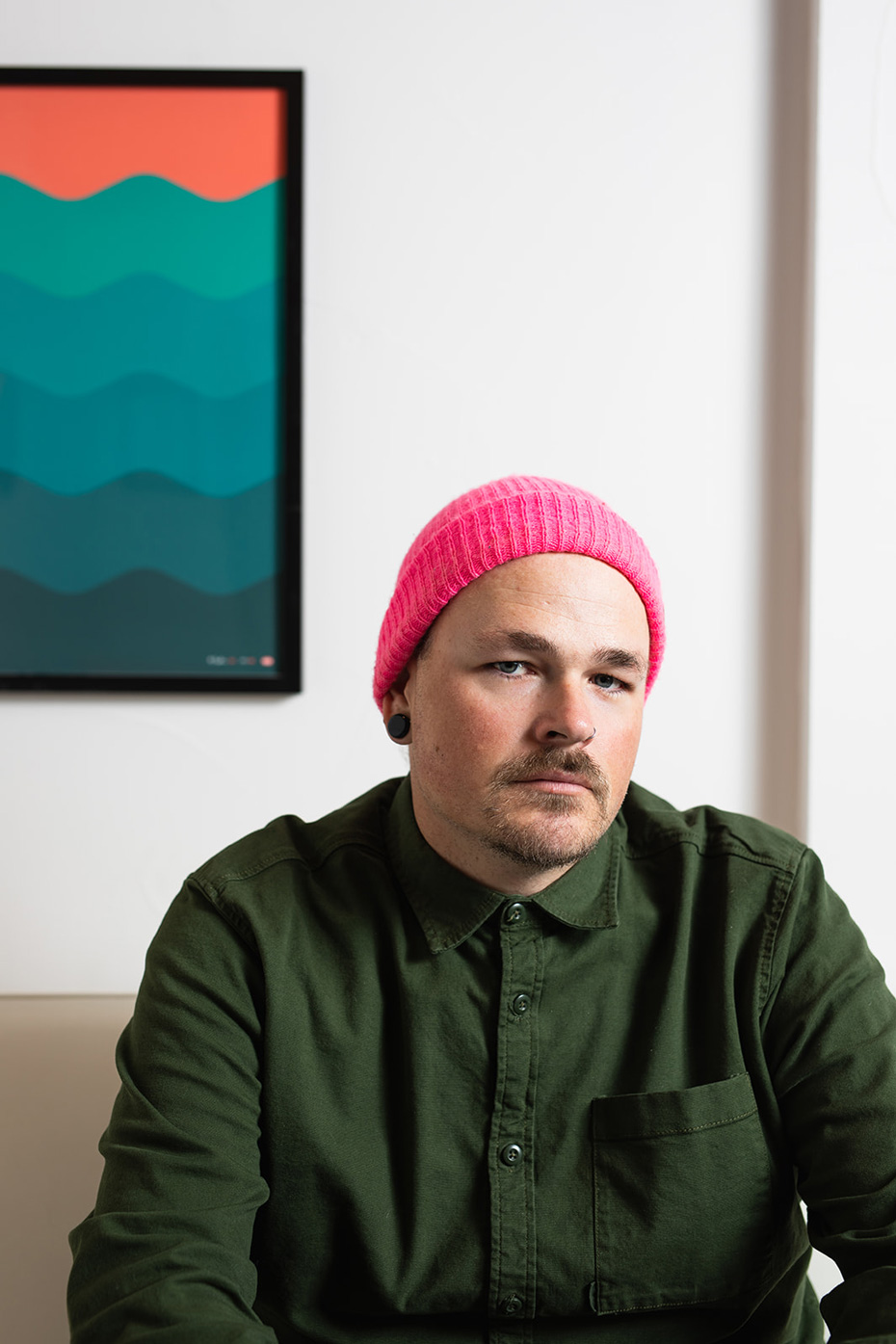 Portrait of a graphic designer wearing a pink beanie  - John Robson Photography