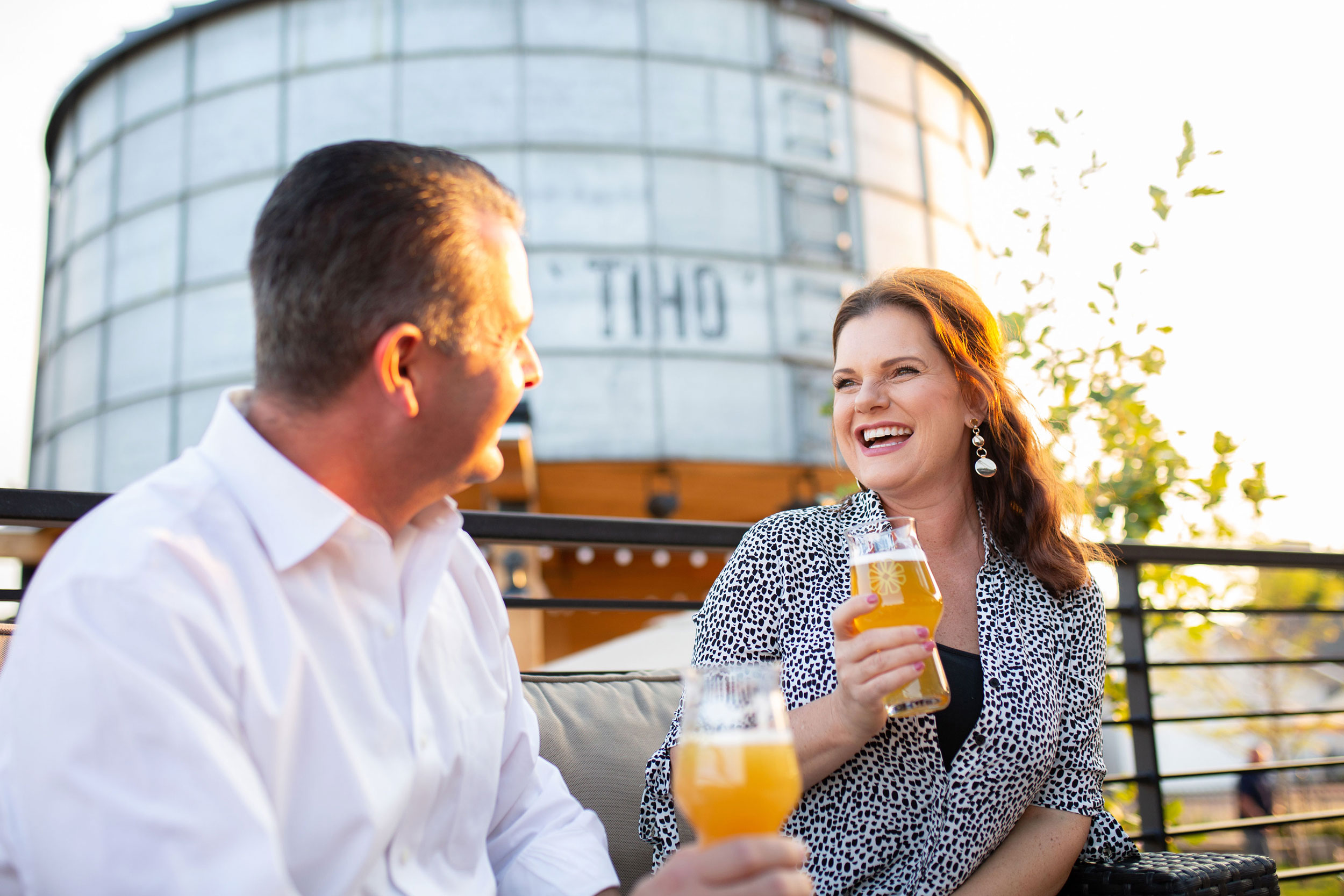 Husband and wife enjoying beers on a patio at Peculiar Ales in Windsor Colorado - John Robson Photography