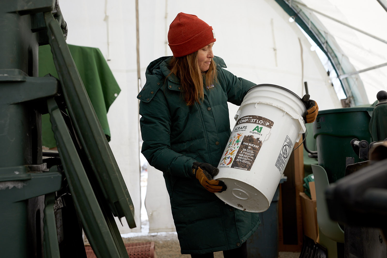 Woman holding a bucket at Scraps Composting for Edible Magazine Denver - John Robson Editorial Photography