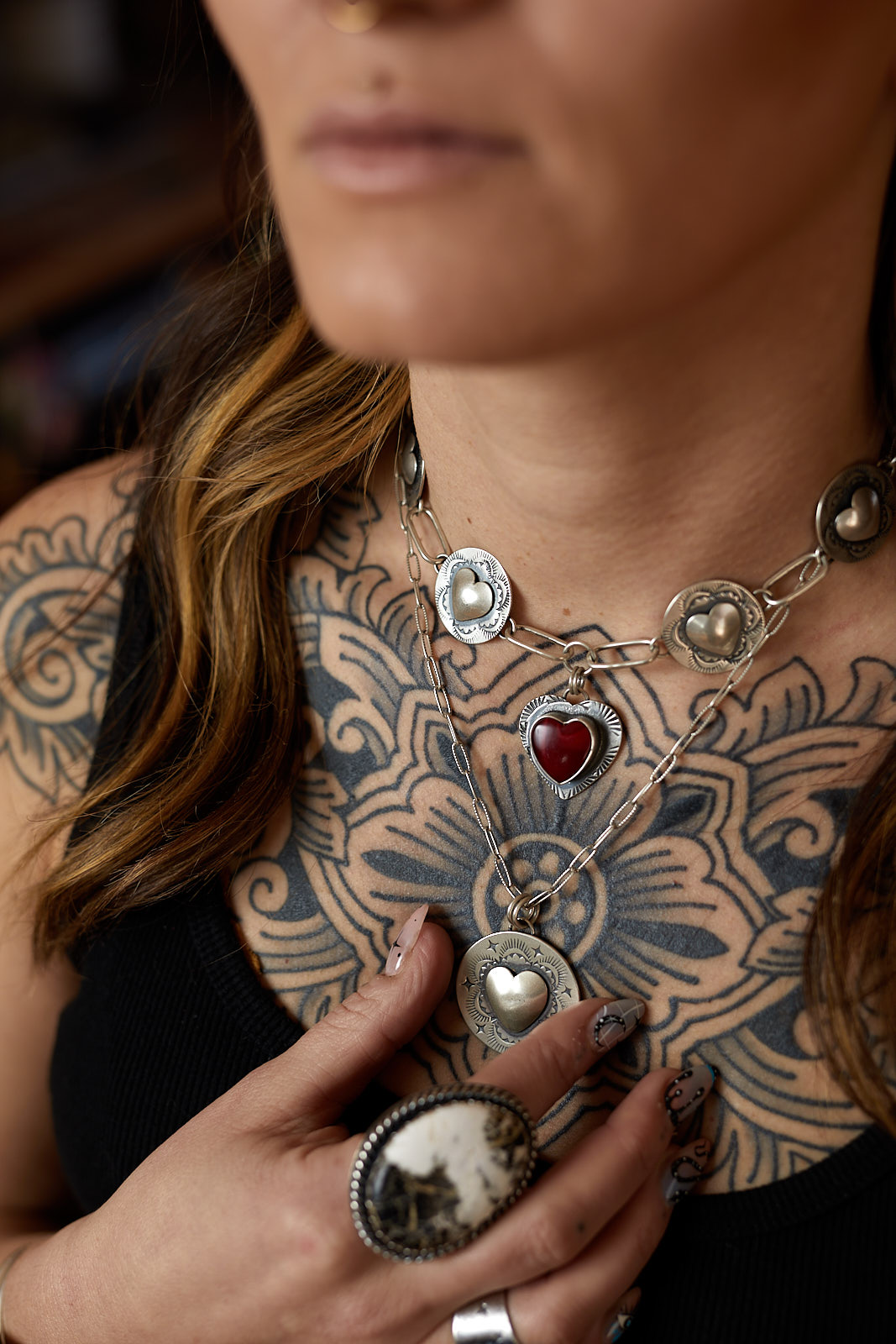 Tattooed model wearing a heart shaped necklace - John Robson Photography