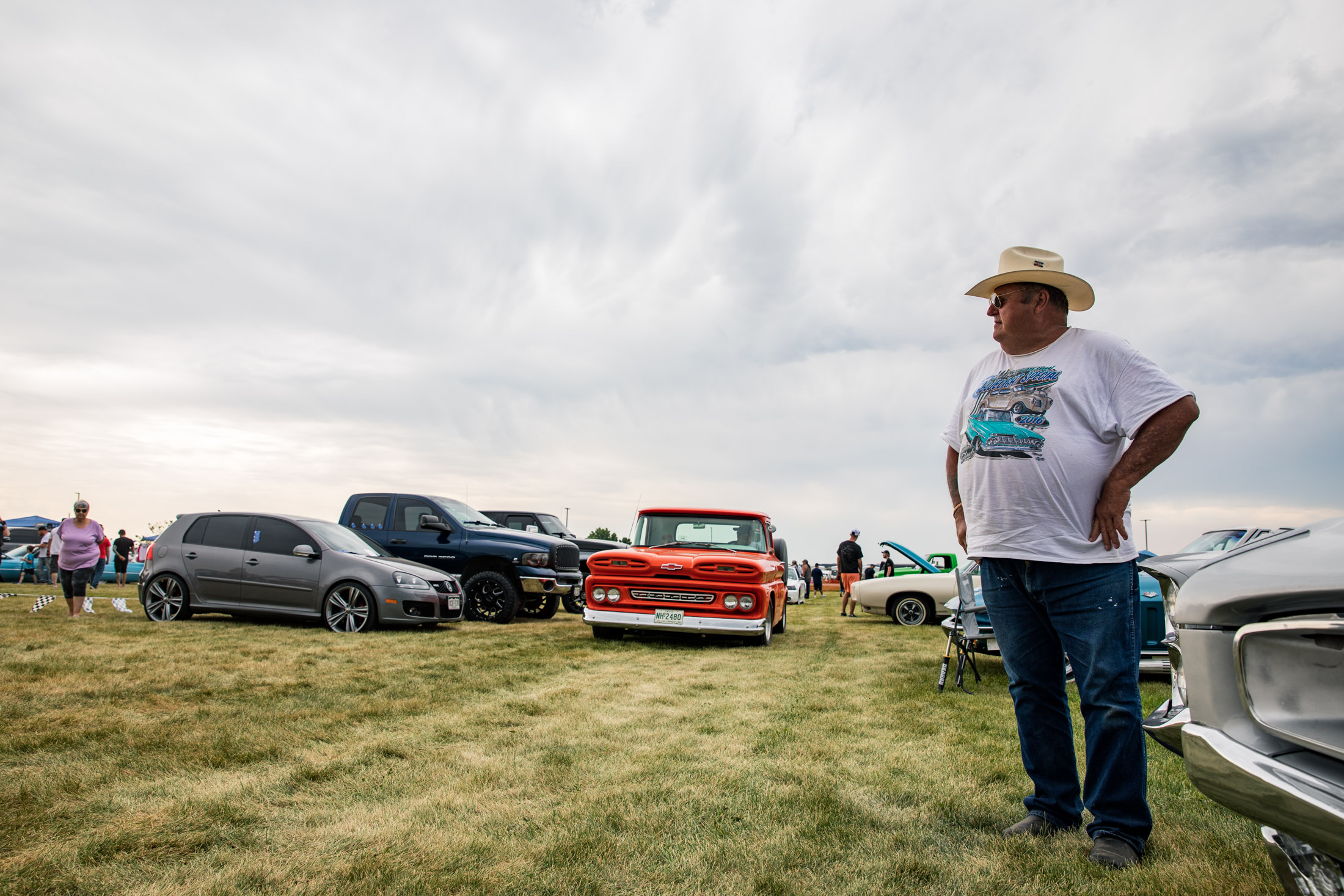 Man with cowboy hat standing tall at a car show in Severance, Colorado - John Robson Photography