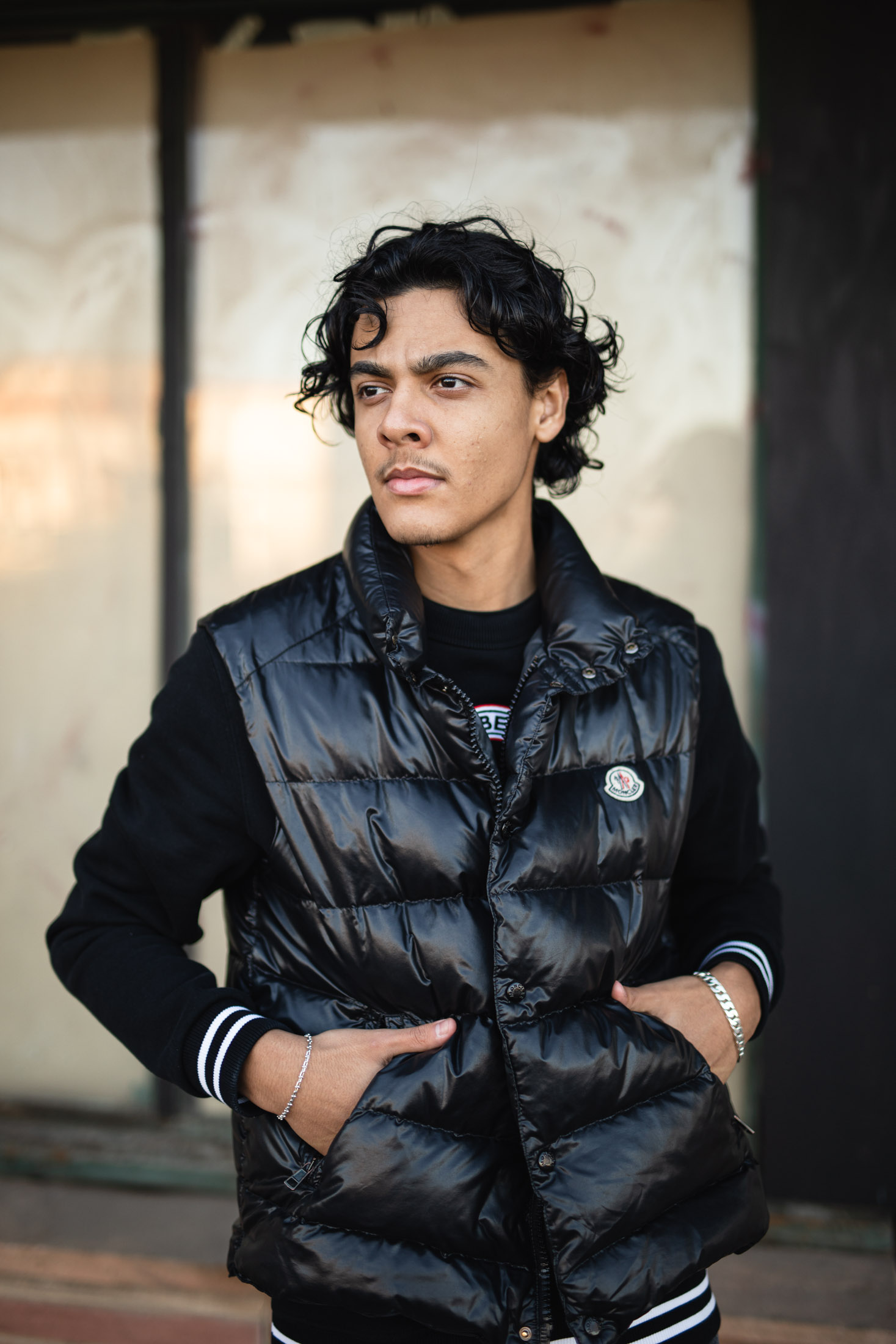 Senior portrait of a young man wearing a black vest in Fort Collins, Colorado - John Robson Photography