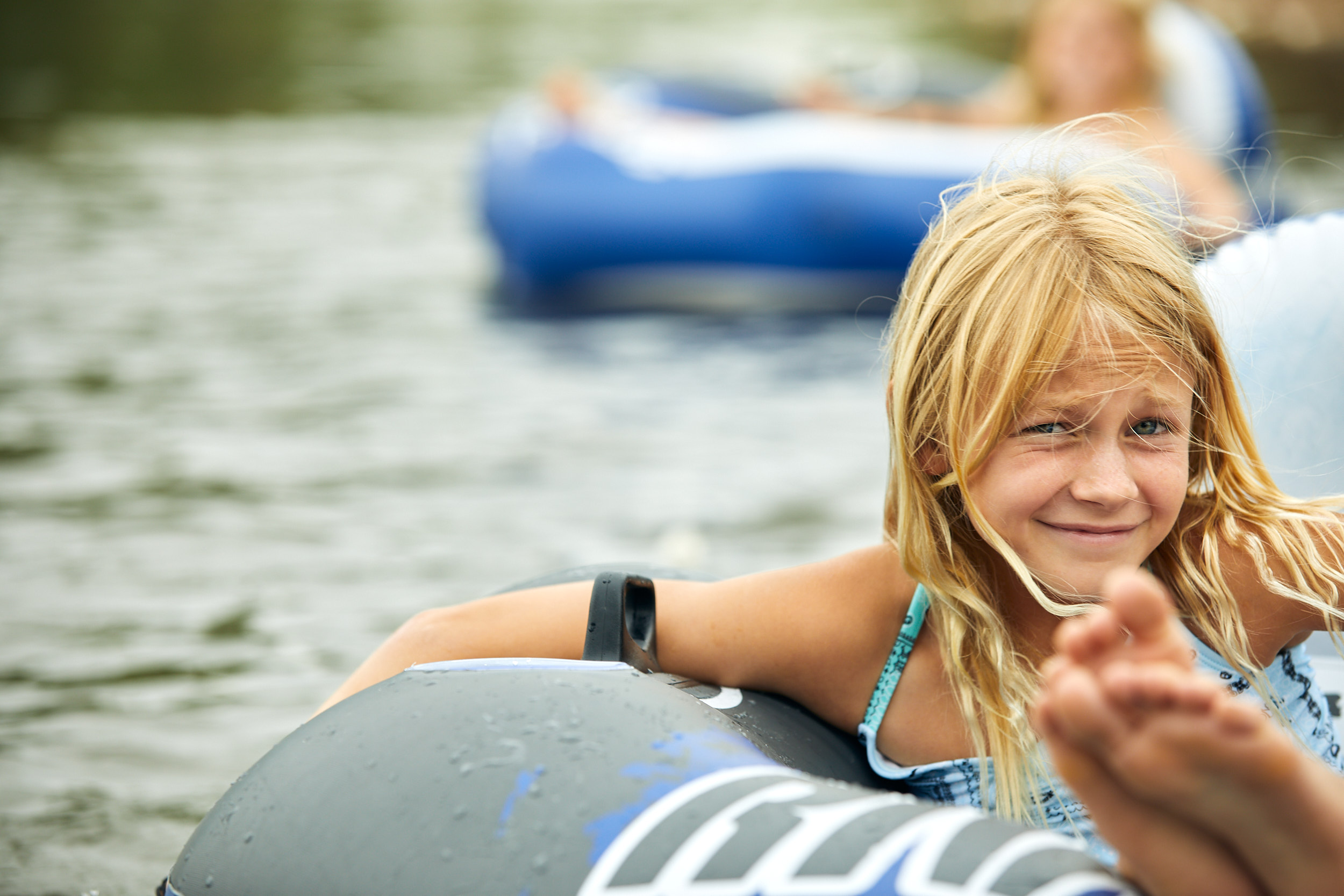 Young girl tubing the Poudre River in Windsor, Colorado - John Robson Photography