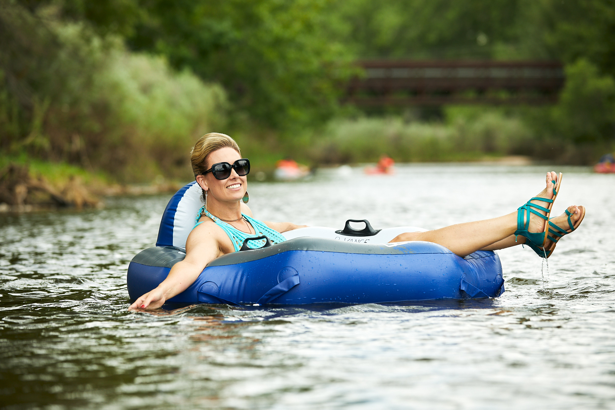 Elegant woman tubing the Poudre River in Windsor, Colorado - John Robson Photography